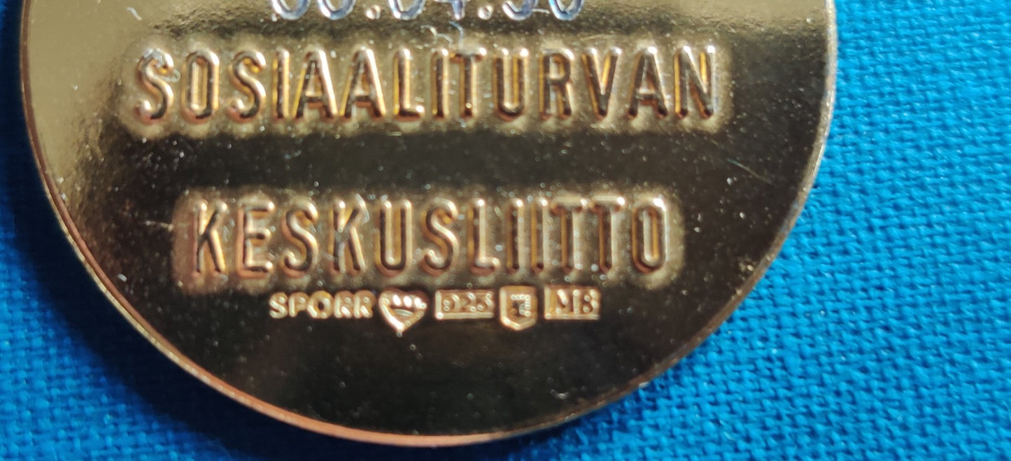 Sosiaaliturvan Keskusliiton Kunniamitali (Kullattu Hopea 925H)